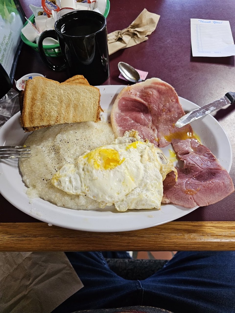 Printed breakfast menu beside a coffee mug